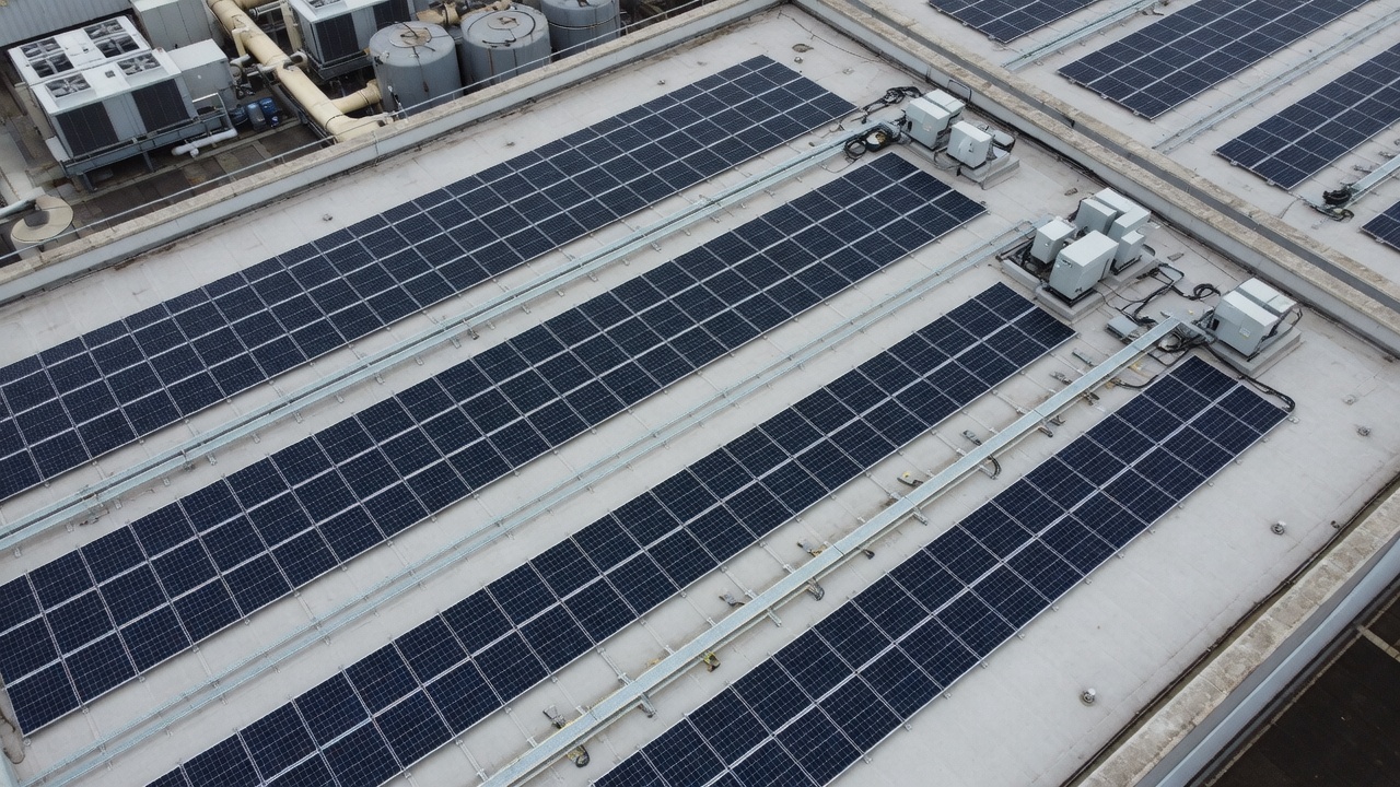 Aerial photograph of a commercial rooftop solar installation.
