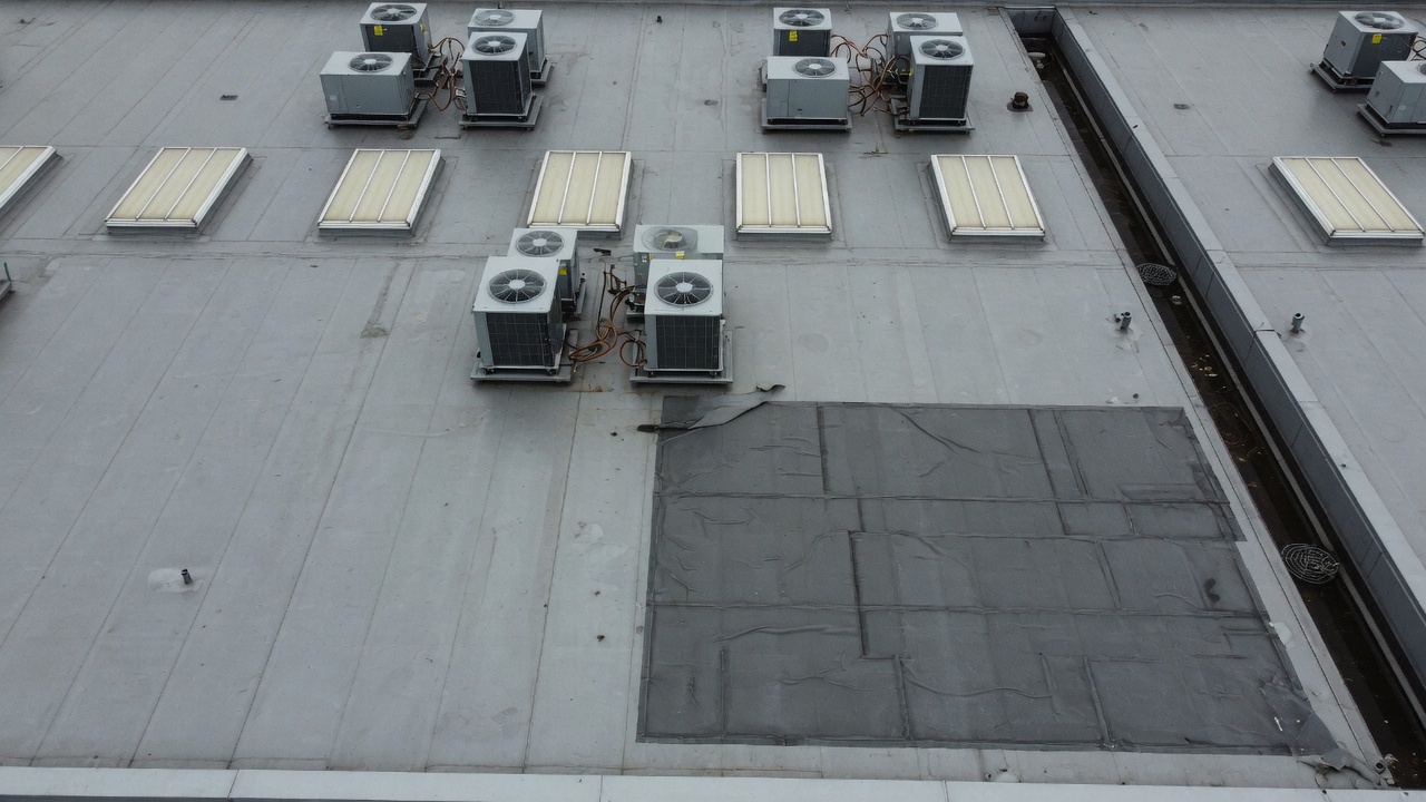 Illustrative visible aerial photograph of a commercial warehouse roof.